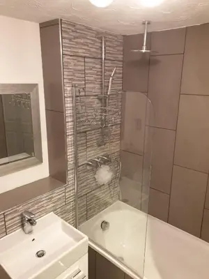 a bathroom with a shower and a sink and a sink at Elegant 2 BR Apartment in Historic Cambridge in Papworth Everard