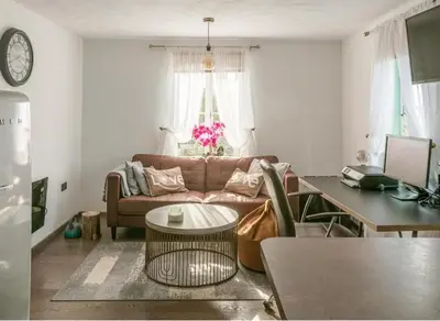 a living room with a couch and a table at Elegant 2 BR Apartment in Historic Cambridge in Papworth Everard
