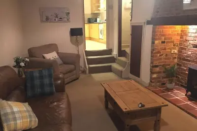 a living room with a couch and a coffee table at Quirky 3 bedroom property in Wymondham