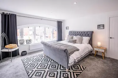 a bedroom with a large bed and a window at One The Old School, Leiston in Leiston
