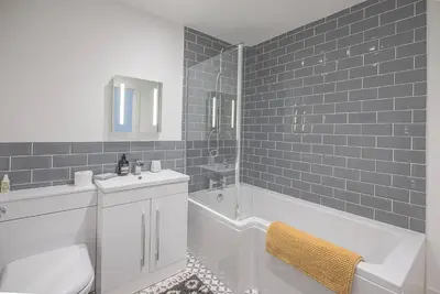 a bathroom with a tub and a sink and a toilet at One The Old School, Leiston in Leiston