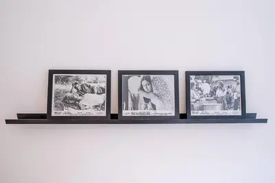 a shelf with four framed pictures on a wall at One The Old School, Leiston in Leiston