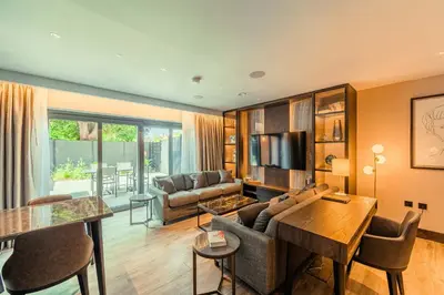 a living room with a couch and a table at The Fellows House Mews in Cambridge