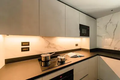 a kitchen with two pots on top of a stove at The Fellows House Mews in Cambridge