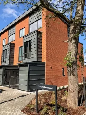 a building with a sign in front of it at The Fellows House Mews in Cambridge