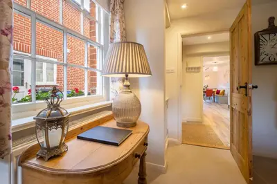 a lamp on a table next to a window at Immaculate luxury retreat in pretty village with great pubs - Box Valley Cottage in Stoke by Nayland