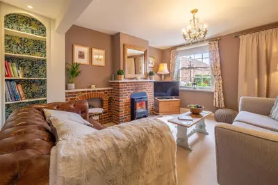 a living room with a couch and a fireplace at Immaculate luxury retreat in pretty village with great pubs - Box Valley Cottage in Stoke by Nayland