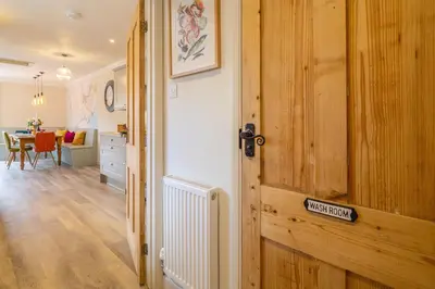 a room with a wooden door and a dining room at Immaculate luxury retreat in pretty village with great pubs - Box Valley Cottage in Stoke by Nayland