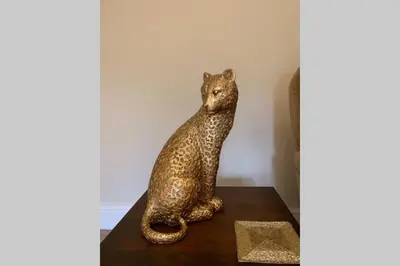 a statue of a cat sitting on a table at The Cartlodge in Wickham Bishops
