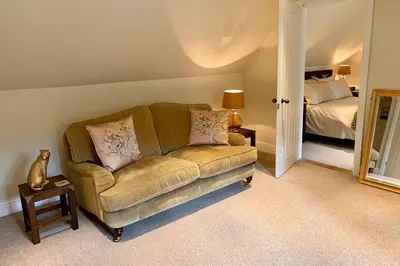 a living room with a couch and a bed at The Cartlodge in Wickham Bishops