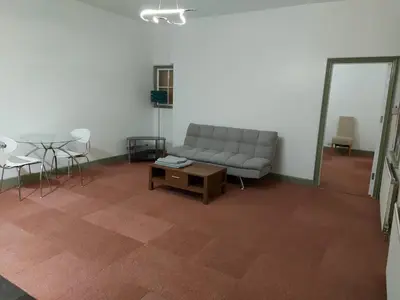 a living room with a couch and a table at Queen Suite in Ipswich