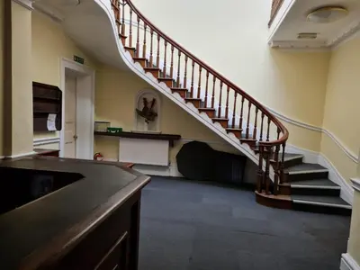 a hallway with a staircase in a house at Costa Suite in Ipswich