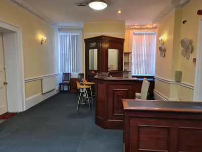 a room with a bar in the middle of a room at Costa Suite in Ipswich