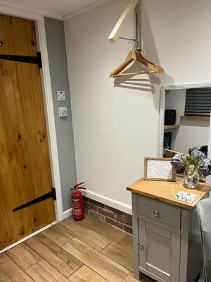 a kitchen with a counter and a wooden door at The Lodge in Little Clacton