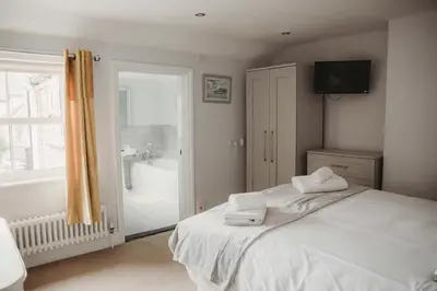 a bedroom with a bed with two towels on it at Hazel's in Leiston