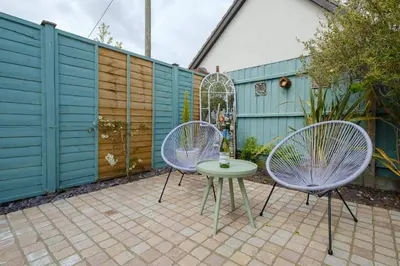 two chairs and a table on a patio at Hazel's in Leiston