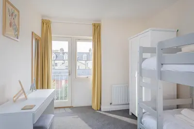 a bedroom with two bunk beds and a window at 3 Bedroom Jesus Green Townhouse with Parking in Cambridge