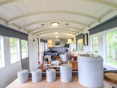 a kitchen and living room in a tiny house at The Carriage at High Barn Heritage in Halstead