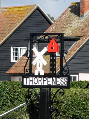a street sign in front of a house at Regatta - A lakeview apartment in Thorpeness - Aldeburgh Coastal Cottages in Thorpeness
