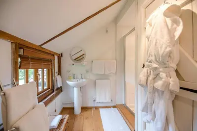 a bathroom with a sink and a toilet in a room at The Hayloft, Clopton in Clopton
