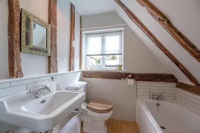 a bathroom with a sink and a toilet and a tub at Lavender Cottage, Middleton in Saxmundham
