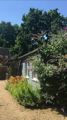 a small house with flowers in front of it at 1 Bed in Waldringfield oc-thstu in Waldringfield