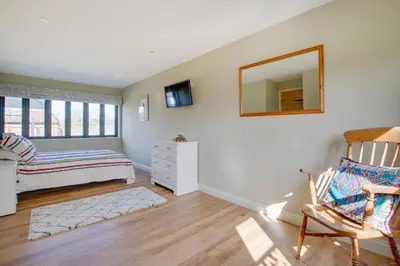 a bedroom with a bed and a mirror and a chair at 2 Bed in Weybread oc-tclwey in Needham