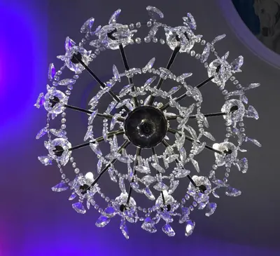 a crystal chandelier hanging from a purple ceiling at Kings Hotel in Newmarket