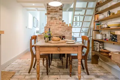 a dining room with a wooden table and chairs at The Wash House, Middleton in Saxmundham