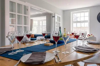 a dining room table with wine glasses on it at The Grange, Aldeburgh in Aldeburgh