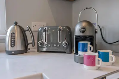 a kitchen counter with a toaster and two coffee cups at The Grange, Aldeburgh in Aldeburgh