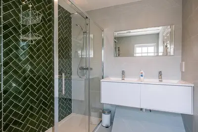 a bathroom with a sink and a glass shower at The Grange, Aldeburgh in Aldeburgh
