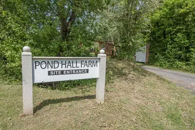 a sign that reads pond hall farm site entrance at Geoff's Rest at Pond Hall Farm in Hadleigh with Private Hot Tub in Ipswich