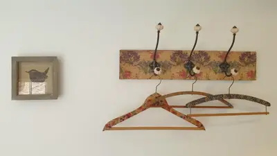 a wooden hanger hanging on a wall with a picture at Argyll House Bed and Breakfast in Westleton