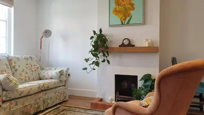 a living room with a couch and a fireplace at Argyll House Bed and Breakfast in Westleton
