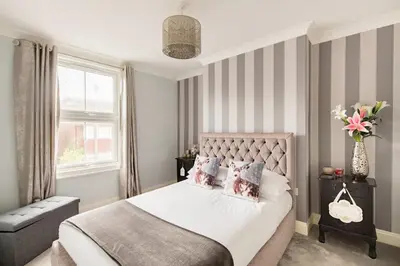 a bedroom with a bed and a window at A Wave From It All in Great Clacton