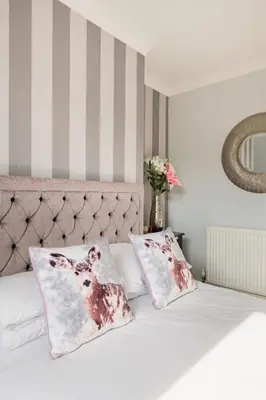 a bedroom with a bed with two pillows on it at A Wave From It All in Great Clacton