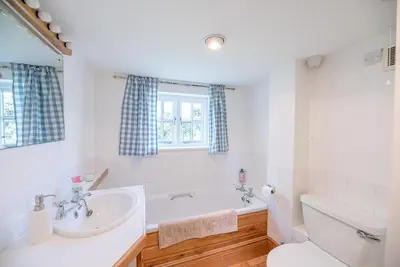 a bathroom with a tub and a sink and a toilet at Heart's Ease in Dallinghoo nr Woodbridge in Woodbridge