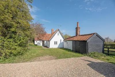 a couple of white houses and a building at Heart's Ease in Dallinghoo nr Woodbridge in Woodbridge