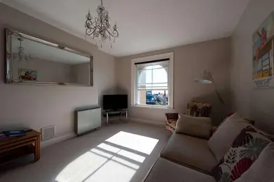 a living room with a couch and a television at The Lookout Penthouse in Harwich