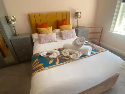 a bedroom with a bed with towels on it at The Lookout Penthouse in Harwich