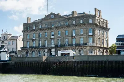 a large building next to a body of water at The Lookout Penthouse in Harwich