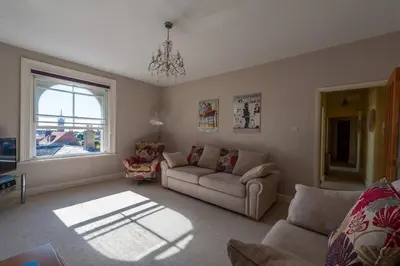 a living room with a couch and a window at The Lookout Penthouse in Harwich
