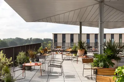 a patio with tables and chairs on a roof at Hyatt Centric Cambridge in Cambridge