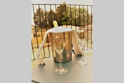 two wine glasses and a blender on a balcony at The Alvaros Apartment in Southend-on-Sea
