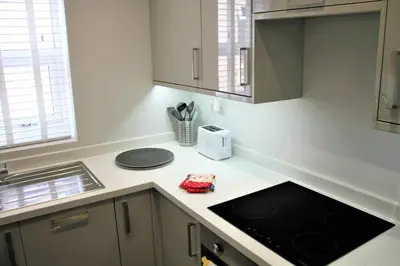 a kitchen with a sink and a counter top at The Alvaros Apartment in Southend-on-Sea