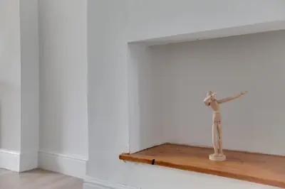 a hammer on a wooden shelf in a white room at Spacious Three Bedroom House - Free Parking & Wifi in Chelmsford