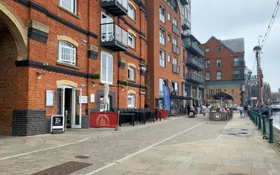 a city street with buildings and people walking on a sidewalk at The Marina Penthouse in Ipswich