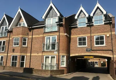 a large red brick building with a garage at 2 Bedroom 2 Double beds Kitchen 2Baths Parking in Bishops Stortford