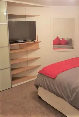 a bedroom with a bed and a flat screen tv at 2 Bedroom 2 Double beds Kitchen 2Baths Parking in Bishops Stortford
